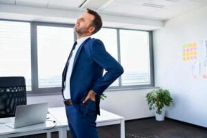 A Person Holding His Back in Pain