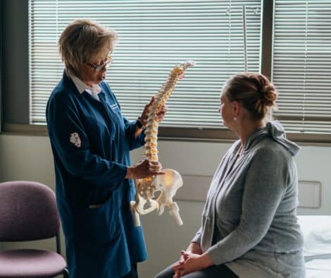 A Pain Specialist Showing A Skeleton To A Patient